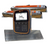 A Gallagher TW-1 electronic Cattle and livestock scale indicator with a black and orange casing stands in front of loadbars on a white background. A textured gray platform is placed beneath the device.