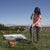 farmers installing a poultry net fence with egg laying hens in the grass